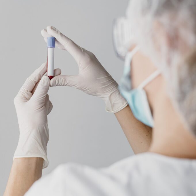 back-view-doctor-holding-blood-sample